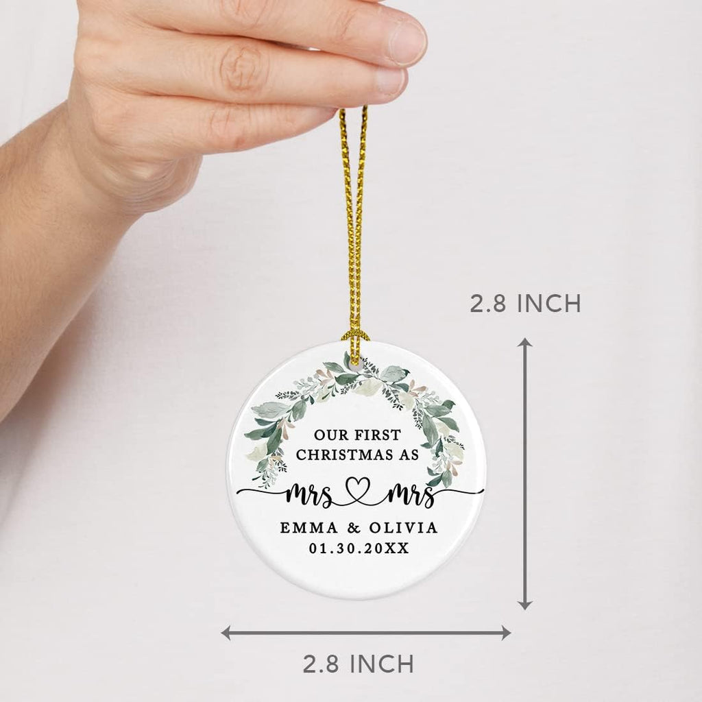 Andaz Press Personalized Our First Christmas As Mrs. & Mrs. Christmas Ornaments 2025 Foliage Wreath 2.8" Round Porcelain Ceramic Lesbian Christmas Ornament Married Couple Gay Women Newlyweds 1-Pack