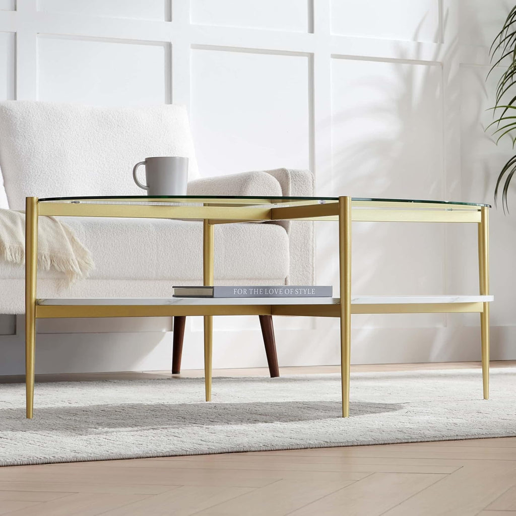 Oval Glass Coffee Table, Mid-Century Modern Design, L43 x W22 x H17 inch, Surfboard Shaped Clear Glass Top and White Marble Finish Wood Shelf, Tapered Legs with Gold Finish Frame