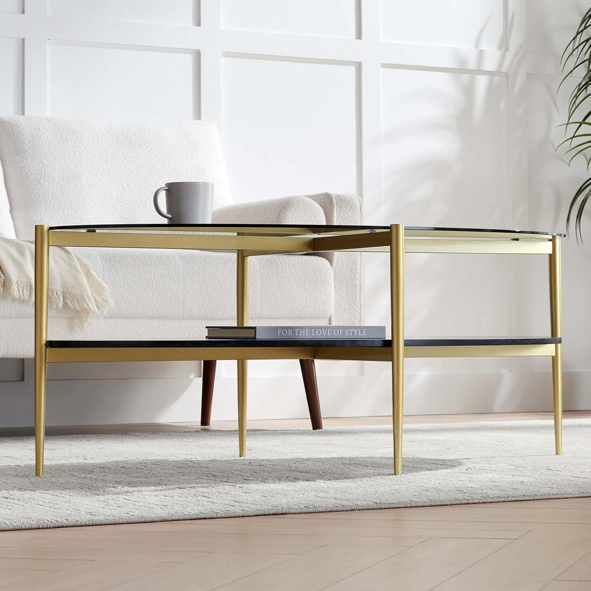 Oval Glass Coffee Table, Mid-Century Modern Design, L43 x W22 x H17 inch, Surfboard Shaped Grey Glass Top and Black Marble Finish Wood Shelf, Tapered Legs with Gold Finish Frame