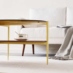 Oval Glass Coffee Table, Mid-Century Modern Design, L43 x W22 x H17 inch, 2-Tier Structure, Olive Shaped Amber Glass Top and Walnut Finish Wood Shelf, Tapered Legs with Gold Finish Frame